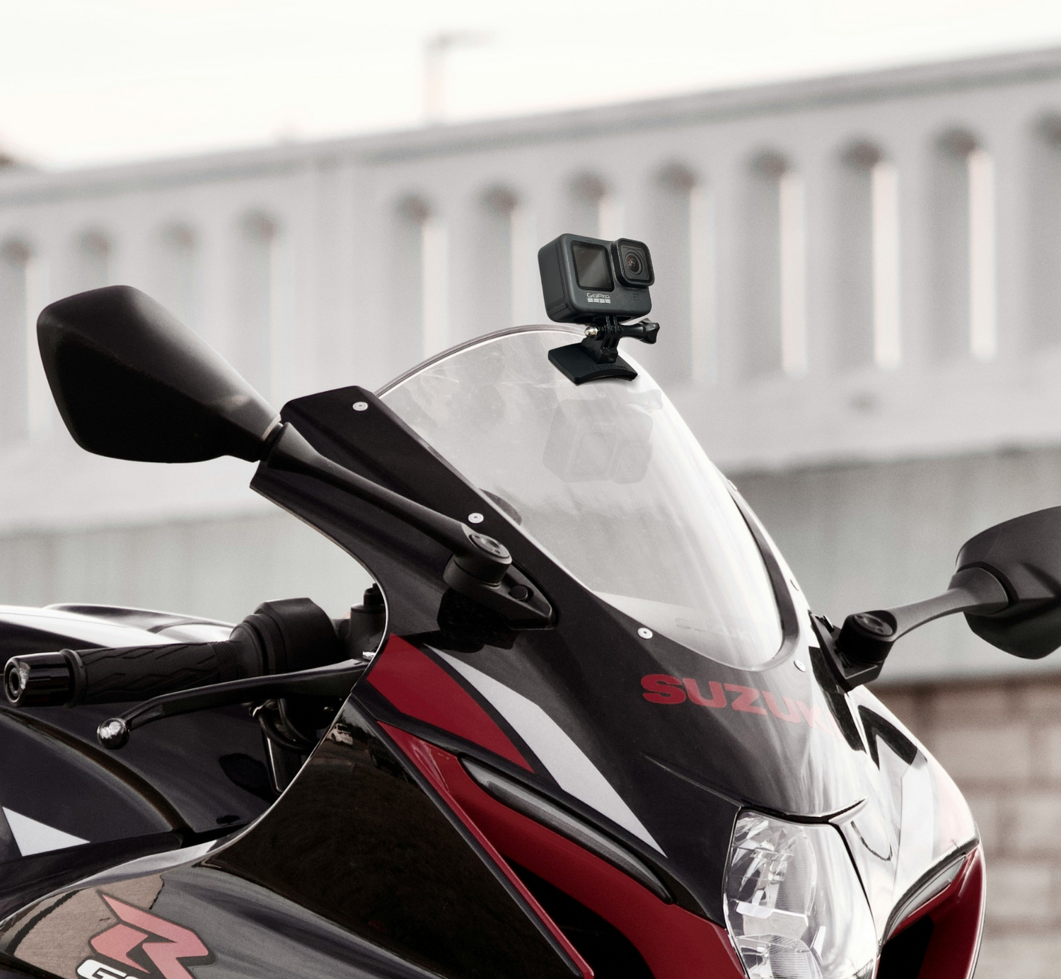Flexible action camera mount on motorcycle windscreen